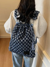 Blue denim checkered drawstring shoulder bag with woven pattern