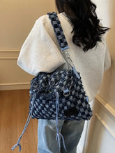 Blue denim checkered drawstring shoulder bag with woven backpack design