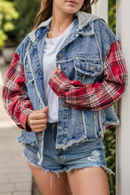 Blue denim jacket with raw hem, plaid sleeves and frayed edges in blue, red, white