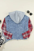 Blue denim jacket with raw hem, plaid sleeves, and hood