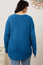 Blue ribbed knit tunic top with thumbhole sleeve and back bow