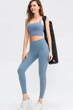 Blue slim fit leggings with mesh panels, sports bra, sneakers, gym bag