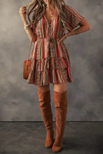 Boho multicolored striped dress with ruffled hem and brown leather boots