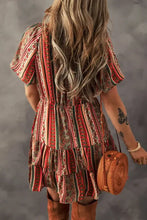 Boho multicolored striped mini dress with ruffled hem and brown leather boots