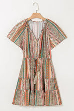 Boho multicolored striped tiered dress with tassels, ruffles, and brown leather boots