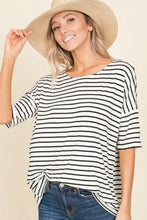 Woman in BOMBOM striped round neck t-shirt, jeans, and straw hat