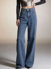 High-waisted blue denim wide leg jeans with a flared silhouette and bow detail at the back