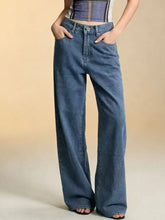 Bow back wide leg jeans in medium blue wash high waisted wide leg denim jeans with classic stitching and button closure
