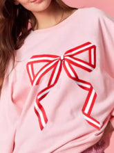 Pink oversized bow crew neck sweatshirt with bold red and white striped bow graphic machine wash cold recommended