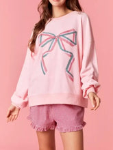 Pink oversized bow crew neck sweatshirt featuring large embroidered pink and teal bow detailing machine wash cold
