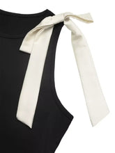 Black sleeveless bodysuit with a cream satin bow detail tied at the shoulder made from smooth fabric