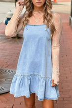 Light blue denim dress with bow detail, spaghetti straps, and ruffle hem mini length perfect for casual wear