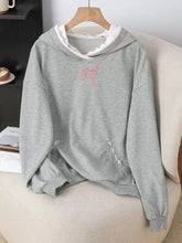 Gray long sleeve hoodie with pink embroidered bow and white lace trim on hood and pocket for stylish comfort