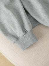 Gray heathered long sleeve hoodie sleeve with ribbed cuffs featuring bow embroidery in soft material