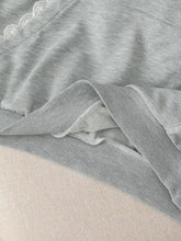 Gray heathered knit long sleeve hoodie with delicate white lace trim along the neckline and bow embroidery
