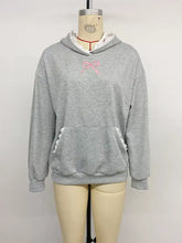 Gray long sleeve hoodie with pink embroidered bow and white lace trim on hood lining and front pocket