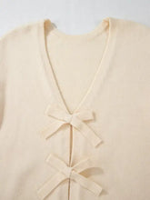 Cream-colored v-neck long sleeve cardigan with bow ties