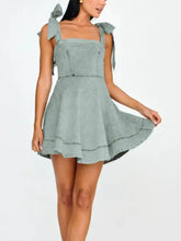 Light blue denim mini dress with square neckline tied shoulder bows and slightly stretchy fabric for comfortable wear