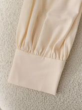Cream-colored satin sleeve cuff with gathered ruched design on bow tie long sleeve shirt