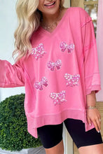 Pink v-neck long-sleeved sweatshirt with sequined bow appliqués made for machine wash cold care