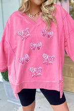 Pink oversized bow v-neck sweatshirt with sequined bow appliqués machine wash cold for easy care