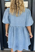 A light blue denim dress with a bowknot round neck, puffed half sleeves, and a gathered waist design