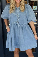 A light blue denim dress with puffed sleeves and bowknot round neck front tie detail