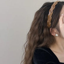 Brown braided hair headband with comb grip on wavy brown hair and pearl earring