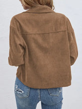Brown corduroy jacket with gold buttons, pockets, button-down front, and relaxed fit