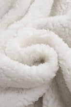 Fluffy white faux fur blanket in brown corduroy jacket with shearling collar