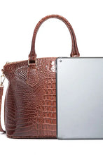 Brown crocodile-embossed leather handbag with top handle and strap