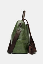 Dark green faux leather backpack bag with brown straps and detachable handle