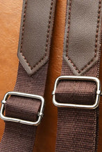 Brown faux leather backpack bag with adjustable tan straps and silver buckles