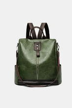 Glossy dark green leather backpack bag with brown faux straps and top handle