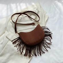 Brown suede fringe crossbody bag with eyelet details, adjustable strap and gold hardware