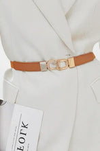 Thin brown geometric double buckle elastic belt with gold interlocking design on white blazer