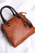 Brown leather bag set with black handles and tassel charm