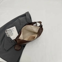 Brown leather crossbody bag with detachable mini pouch and fabric lining