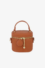 Tan leather crossbody bag with gold hardware and zipper