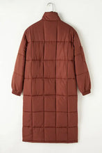 Rust-colored quilted puffer coat with fur trim, belt, and high collar