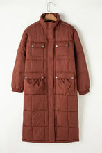 Rust-colored quilted puffer coat with fur trim, belt, pockets, and high collar