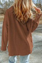 Brown textured long sleeve jacket with button details and pockets