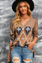 Woman in brown western print buttoned long-sleeved V-neck top and ripped jeans