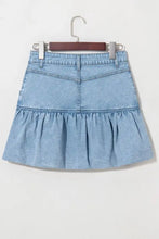 Light blue denim mini skirt with bubble hem ruffle and front pockets in soft denim material