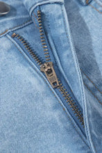 Light-wash denim mini skirt featuring a bubble hem and metallic zipper with sbs brand pull tab