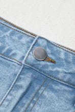 Light-wash denim mini skirt with bubble hem featuring silver button and brown stitching details
