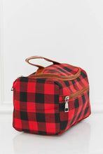 Red and black buffalo plaid printed makeup bag with brown leather handle