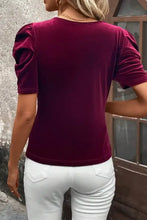 Burgundy velvet puff sleeve top with scoop neck, paired with white pants