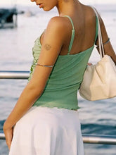 A mint green sleeveless cami with delicate ruching and thin straps in butterfly embellished slim fit design