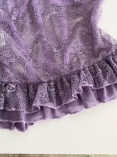 A delicate lavender butterfly lace tube top with intricate floral patterns and a ruffled hem in lace tube design